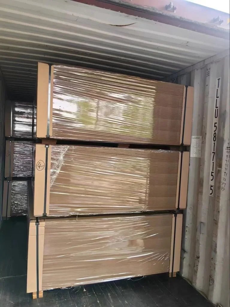 large palletized boards strapped and stored in warehouse loading area