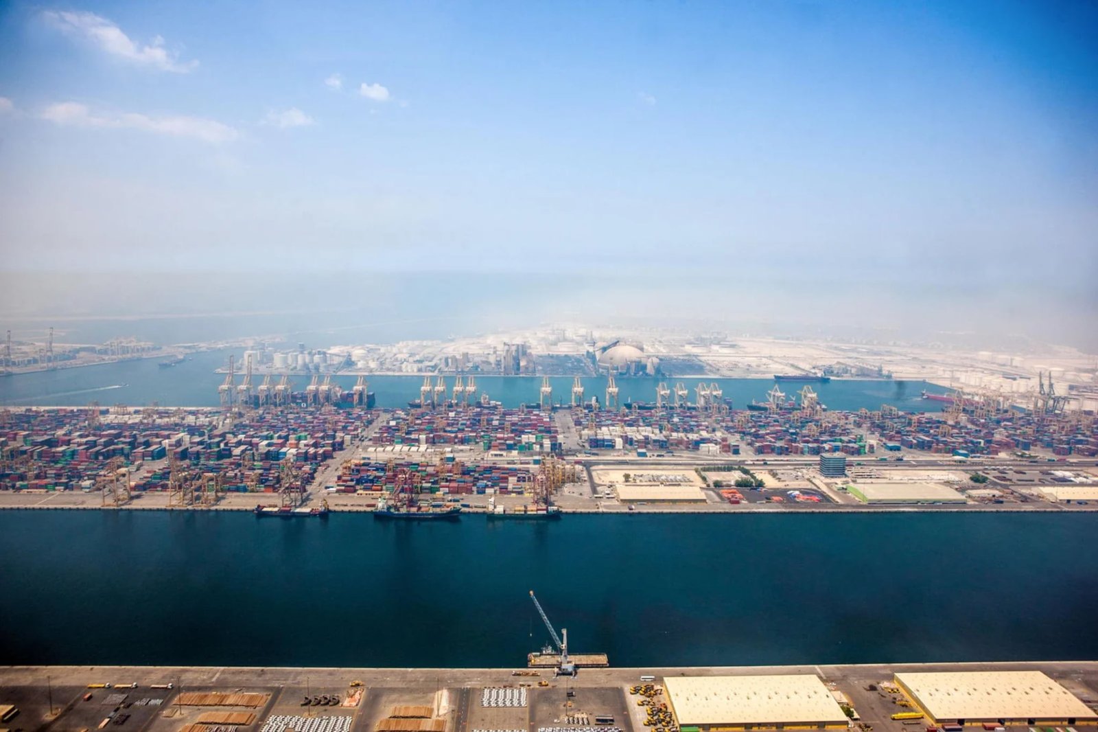 aerial view of busy container port with cranes and cargo ships