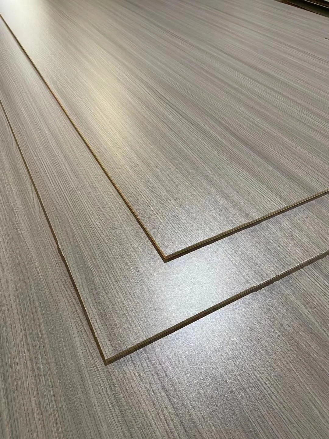 Stacked wood veneer plywood sheets with smooth grain texture surface closeup